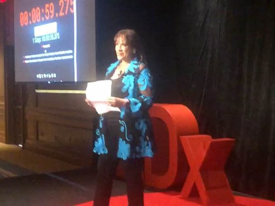 Fran on the TEDx stage with the 59.275-second timer behind her
